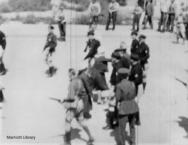 Carbon_County_Strike_Women_from_National_Miners_Union_March_confront_vanguard_of_police_forces_in_Main_Street_Still_from_film_Price_Utah_September_11_1933.jpg